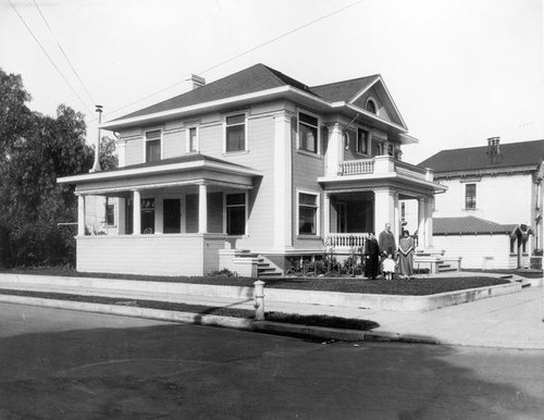 Family in front of house