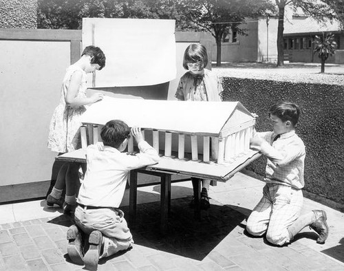 Children constructing a building model