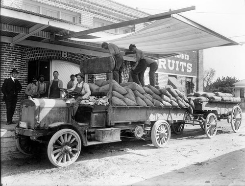 Transporting sacks by open truck