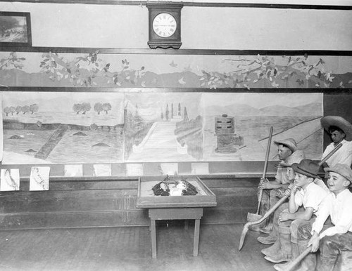 Classroom presentation on water with children holding shovels