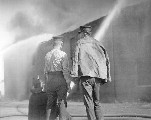 Firefighter extinguishing a building fire