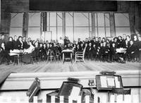 Seated theatre players on stage