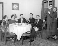 Players performing a dining room scene