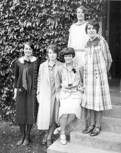 Women pose on steps