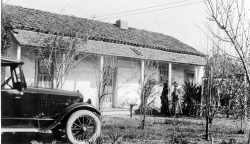 Two women in front of a house