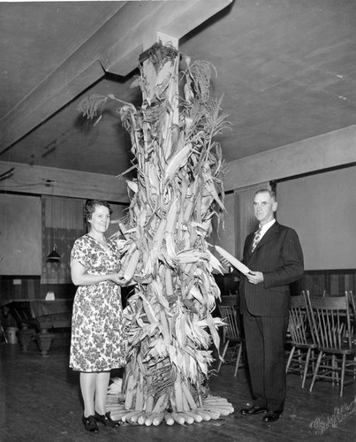 Posing with corn stalks indoors