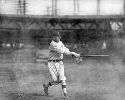 Male baseball player swinging a bat