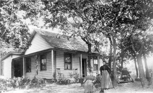 Two women in front of a house