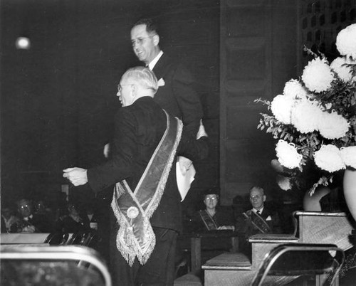 Two men stand before the assembly at the Grange convention