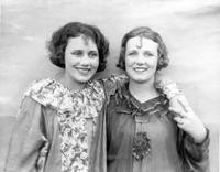 Two women in costume smiling