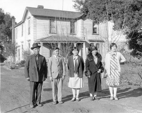 Araki family members standing in front of their house