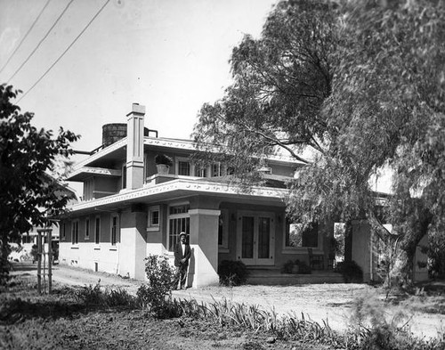 Man standing beside a house