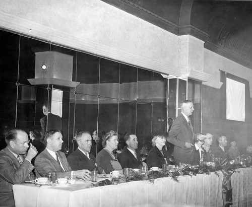 Unidentified man speaking at banquet