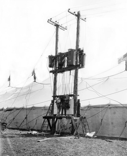 Utility poles and tent