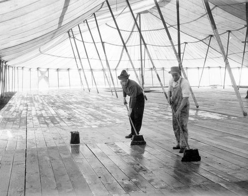 Two men oiling the floor