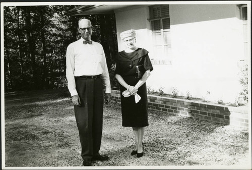 Charles Protzman and his wife standing in a yard, 1961-05