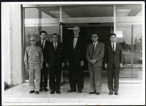 Charles Protzman standing with five men