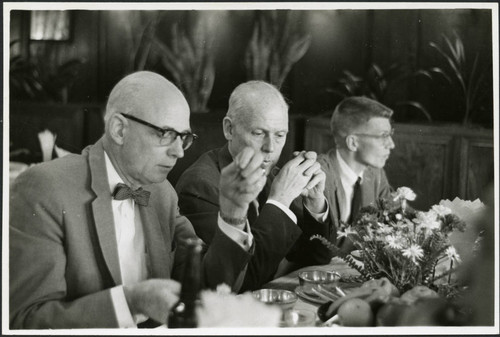 Charles Protzman sitting with two men — Calisphere