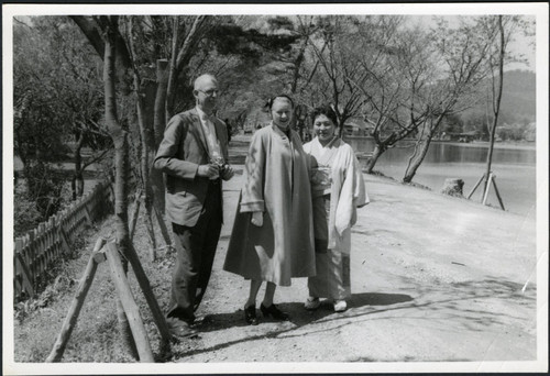 Charles Protzman and his wife standing near water — Calisphere