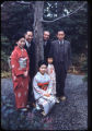 Six individuals standing around a tree