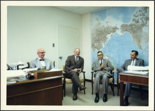 Charles Protzman sitting in a room with three men, 1969-07-24