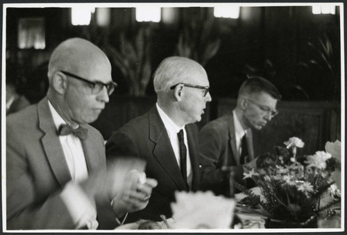 Charles Protzman sitting with two men