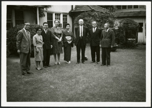 Frank and Priscilla Polkinghorn standing with six people