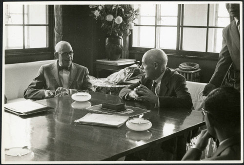 Charles Protzman sitting with two men