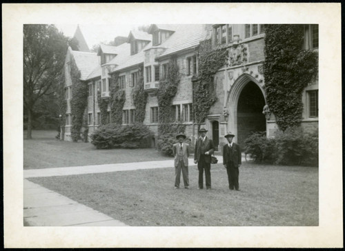 Frank Polkinghorn standing between two men, 1950-09-30