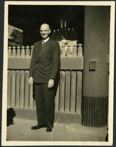 Charles Protzman standing in front of a statue