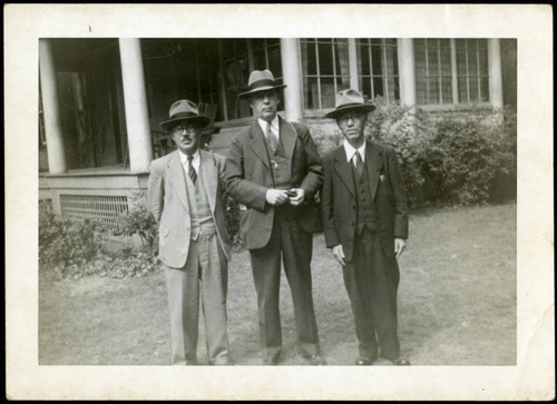 Frank Polkinghorn standing between two men, 1950-09-30