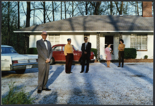 Charles Protzman standing in front of a house — Calisphere
