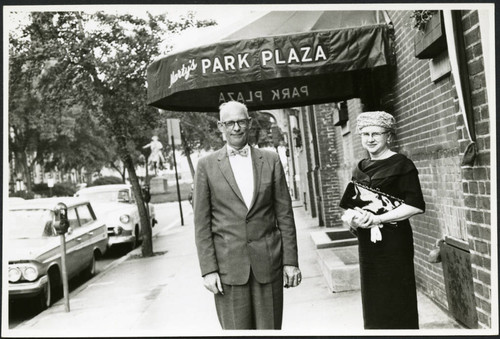 Charles Protzman and his wife standing in front of a building, 1961-05