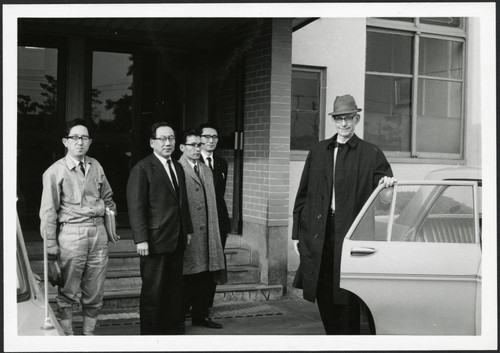 Charles Protzman standing near an automobile