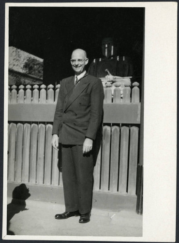 Charles Protzman standing in front of a statue