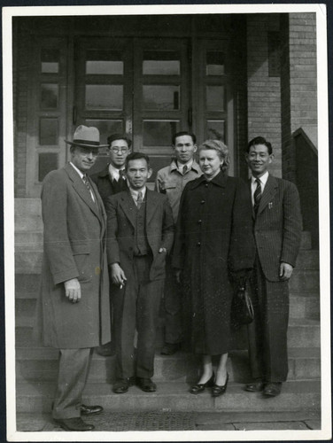 Charles Protzman and his wife standing with four men