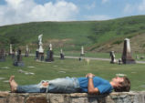 Student lounging near cemetery
