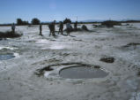 Students walk on dry riverbed