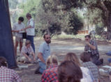 Instructor teaching a class under a tree