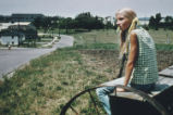 Girl seated on seed drill