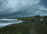 Coastal shores and sweeping dark clouds