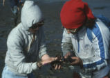 Students holding clams