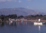 People with rafts on the lake