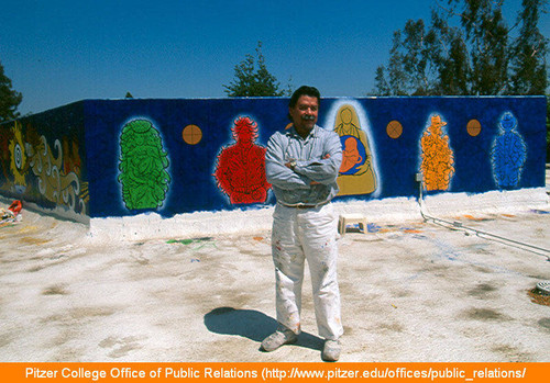Yando Rios in front of serpent mural