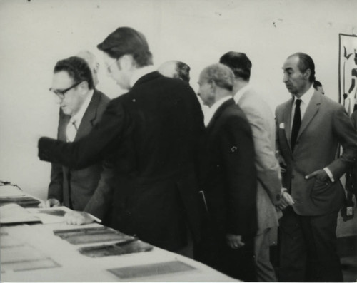 Henry Kissinger and James Robinson with codices at the Coptic Museum