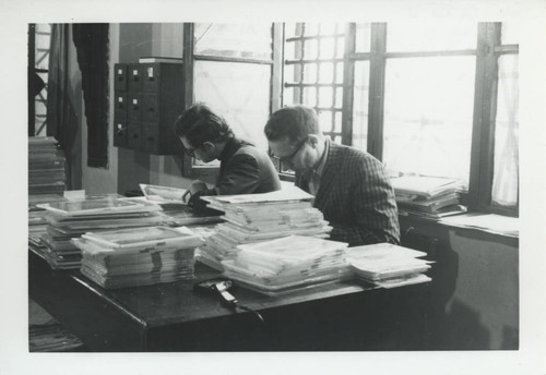 Jim Brashler and John Sieber studying manuscripts