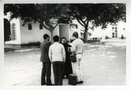 Scholars with Coptic priest