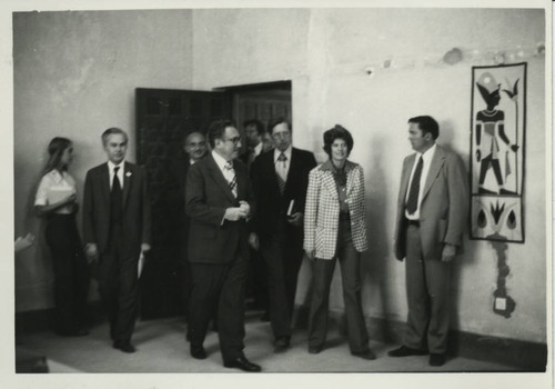 Henry Kissinger enters a room at the Coptic Museum