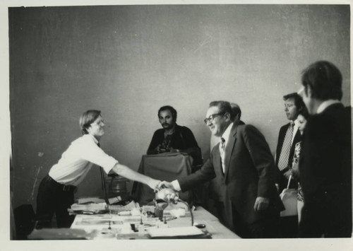 Henry Kissinger shakes hands with Stephen Emmel at the Coptic Museum