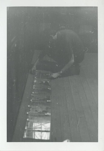 Scholar placing Nag Hammadi codices on the floor